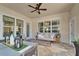 Inviting patio with stylish furniture, outdoor dining area, and a cozy fire pit for relaxing evenings at 14204 Barrington Stowers Dr, Lithia, FL 33547