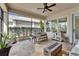 Screened patio with ceiling fan, outdoor seating, brick flooring and a modern fire pit at 14204 Barrington Stowers Dr, Lithia, FL 33547