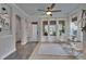 Bright sitting area featuring large windows, a ceiling fan, and a cozy reading nook with comfortable chairs at 14204 Barrington Stowers Dr, Lithia, FL 33547