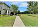 Neighborhood sidewalk lined with manicured lawns and mature trees providing a serene suburban setting at 14204 Barrington Stowers Dr, Lithia, FL 33547