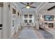 Bright sun room boasts a ceiling fan, stylish decor, and floor-to-ceiling windows with natural light at 14204 Barrington Stowers Dr, Lithia, FL 33547