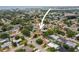 Aerial view of home showing nearby city, mature trees, and proximity to neighborhood amenities at 14330 Oliver St, Largo, FL 33774