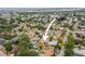Aerial view showcasing the home, a fenced yard, lush trees, and proximity to the water at 14330 Oliver St, Largo, FL 33774