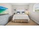 Cozy bedroom featuring a large bed, a modern TV on a dresser, and serene artwork for a relaxing atmosphere at 14330 Oliver St, Largo, FL 33774