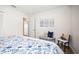 Serene bedroom featuring a patterned bedspread, comfortable seating, and elegant artwork for a tranquil retreat at 14330 Oliver St, Largo, FL 33774