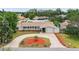 Charming single story home featuring a circular driveway and well-manicured landscaping at 14330 Oliver St, Largo, FL 33774