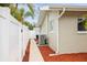Side view of house showcasing a clean exterior, walkway, and privacy fence at 14330 Oliver St, Largo, FL 33774