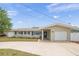 Charming single-story home featuring a well-manicured lawn, neutral color, and an attached two-car garage at 14330 Oliver St, Largo, FL 33774
