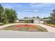Inviting single-story home with a circular driveway and well-manicured landscaping at 14330 Oliver St, Largo, FL 33774