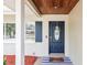 Close-up of a stylish front door featuring a decorative wreath and a welcoming entrance mat at 14330 Oliver St, Largo, FL 33774
