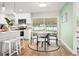 Bright kitchen with white cabinetry, stainless steel appliances, and adjacent dining area with backyard view at 14330 Oliver St, Largo, FL 33774