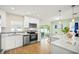 Modern kitchen featuring white cabinetry, stainless steel appliances, and an open layout at 14330 Oliver St, Largo, FL 33774