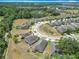 An aerial view showcases community layout with manicured lawns and mature trees at 15579 Stone House Dr, Brooksville, FL 34604