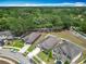 Aerial view of homes in a neighborhood with well-maintained lawns and trees at 15579 Stone House Dr, Brooksville, FL 34604