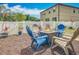 Backyard fire pit seating area with a privacy fence and landscaping at 15579 Stone House Dr, Brooksville, FL 34604