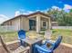 Inviting backyard features a fire pit with Adirondack chairs and a covered patio, perfect for outdoor relaxation at 15579 Stone House Dr, Brooksville, FL 34604