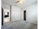 This bedroom features neutral walls, a ceiling fan, plush carpet and a sliding door closet at 15579 Stone House Dr, Brooksville, FL 34604