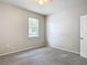 Bedroom with carpet floors and a window at 15579 Stone House Dr, Brooksville, FL 34604