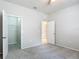 Neutral bedroom featuring an open closet door and adjoining rooms for flexible living at 15579 Stone House Dr, Brooksville, FL 34604