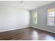 Sunlit bedroom with hardwood floors and a ceiling fan at 15579 Stone House Dr, Brooksville, FL 34604
