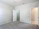 Cozy bedroom with neutral carpet, walk-in closet, and a door leading to the hallway and bath at 15579 Stone House Dr, Brooksville, FL 34604
