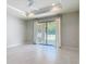 Bedroom with a ceiling fan and sliding glass doors to the lanai at 15579 Stone House Dr, Brooksville, FL 34604