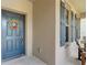 A charming front door, complete with a wreath and sidelight windows at 15579 Stone House Dr, Brooksville, FL 34604