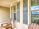 Cozy front porch with wooden rocking chairs and views of the neighborhood street at 15579 Stone House Dr, Brooksville, FL 34604