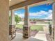 Inviting covered front porch showcasing stone pillars, a rocking chair, and a pleasant neighborhood view at 15579 Stone House Dr, Brooksville, FL 34604