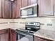 Stylish kitchen includes granite countertops and stainless steel appliances at 15579 Stone House Dr, Brooksville, FL 34604