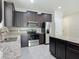 Kitchen with granite countertops, stainless steel appliances, dark cabinets and tile flooring at 15579 Stone House Dr, Brooksville, FL 34604