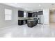 Contemporary kitchen with dark cabinetry, stainless steel appliances, and a center island for added prep space at 15579 Stone House Dr, Brooksville, FL 34604