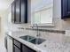 Granite countertops and stainless steel sink in the stylish kitchen at 15579 Stone House Dr, Brooksville, FL 34604
