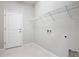 Laundry room with tiled floors, utility connections, and door to the outside at 15579 Stone House Dr, Brooksville, FL 34604