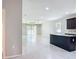 Open-concept living space with tile floors, a ceiling fan, and sliding glass doors to the backyard at 15579 Stone House Dr, Brooksville, FL 34604