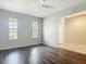 Spacious living room with hardwood floors, neutral paint, and natural light from the windows at 15579 Stone House Dr, Brooksville, FL 34604