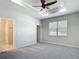 Spacious main bedroom with tray ceiling, fan, and natural light from a window at 15579 Stone House Dr, Brooksville, FL 34604
