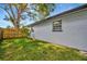 A spacious, grassy backyard with a privacy fence provides a peaceful and secluded outdoor space at 15591 Darien Way, Clearwater, FL 33764