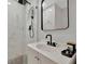 Modern bathroom featuring a black rainfall shower head and a glass shower door at 15591 Darien Way, Clearwater, FL 33764