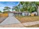 Inviting single-story home with well-maintained lawn, long driveway, and tasteful landscaping at 15591 Darien Way, Clearwater, FL 33764