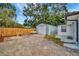 Backyard showcasing a detached garage and charming outdoor seating, ideal for storage and leisure at 15591 Darien Way, Clearwater, FL 33764