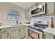 A well-equipped kitchen featuring stainless steel appliances and modern finishes at 15591 Darien Way, Clearwater, FL 33764