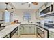 Well-lit kitchen featuring stainless steel appliances and modern lighting fixtures at 15591 Darien Way, Clearwater, FL 33764