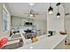 Bright kitchen with stainless steel appliances, white countertops, and a ceiling fan at 15591 Darien Way, Clearwater, FL 33764