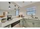 Spacious kitchen showcasing stainless steel appliances, light countertops, and ample storage at 15591 Darien Way, Clearwater, FL 33764