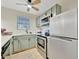 Updated kitchen with stainless steel appliances, light green cabinets, and plenty of counter space at 15591 Darien Way, Clearwater, FL 33764