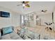 Open-concept living area with breakfast bar, light hardwood floors and seamless flow to kitchen and dining at 15591 Darien Way, Clearwater, FL 33764
