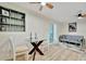 Open-concept living area with light hardwood floors, glass table and seamless flow to dining at 15591 Darien Way, Clearwater, FL 33764