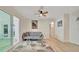 Inviting living room with ceiling fan, light hardwood floors, comfortable seating, and sliding glass door at 15591 Darien Way, Clearwater, FL 33764