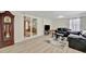 Spacious living room with hardwood floors, large window, glass sliding door and comfortable seating at 15591 Darien Way, Clearwater, FL 33764